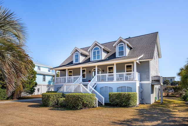 cape cod house featuring covered porch