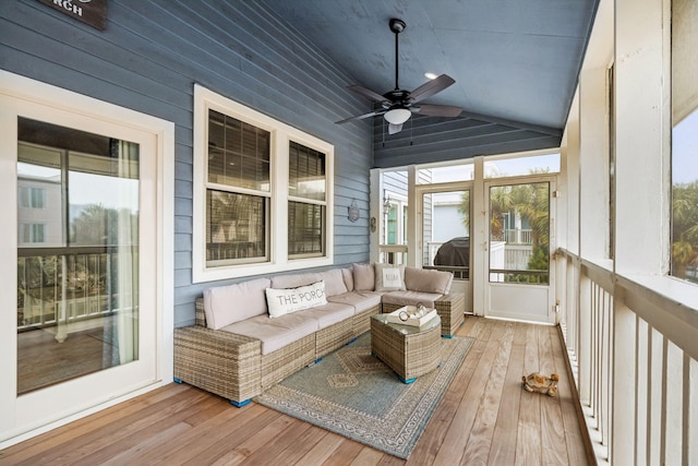 sunroom featuring lofted ceiling and ceiling fan