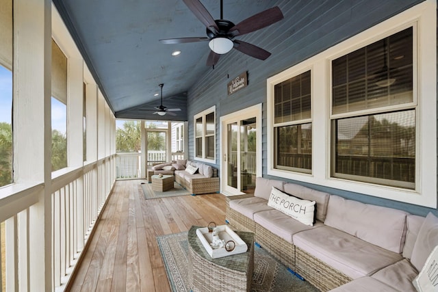 unfurnished sunroom with ceiling fan and vaulted ceiling