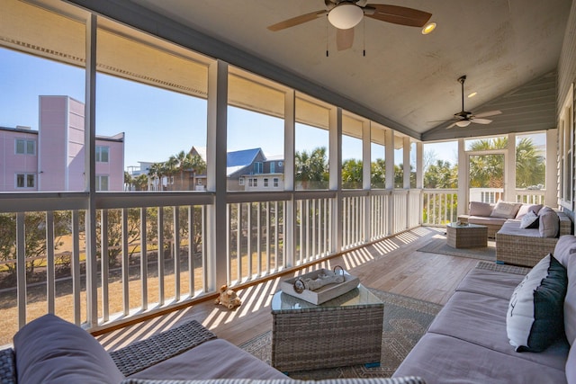 sunroom / solarium featuring ceiling fan and vaulted ceiling