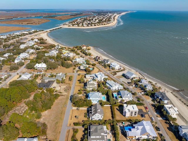 aerial view with a water view and a beach view