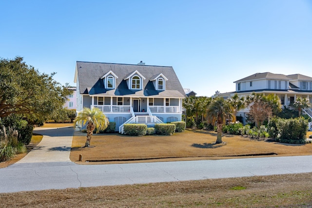 view of front of home with a porch and a front lawn