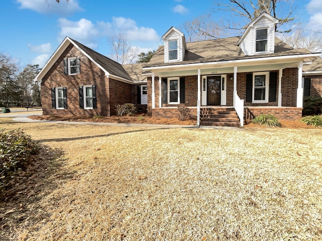 new england style home featuring covered porch