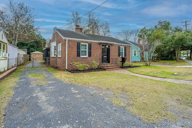 view of front of home featuring cooling unit and a front yard