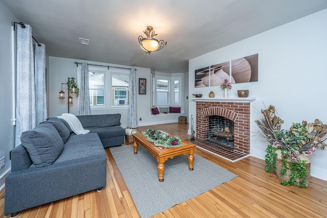 living room featuring hardwood / wood-style flooring and a fireplace