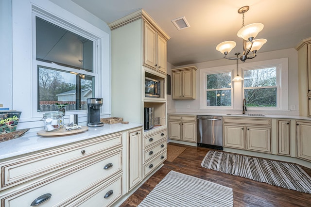 kitchen with sink, decorative light fixtures, dark hardwood / wood-style floors, dishwasher, and cream cabinetry