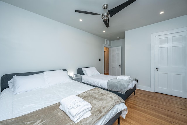 bedroom with ceiling fan and light hardwood / wood-style floors