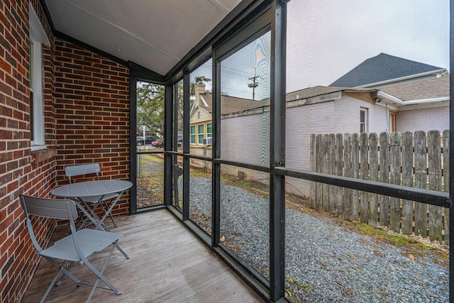 unfurnished sunroom with vaulted ceiling