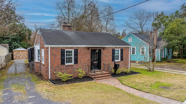 view of front of house with a shed and a front yard