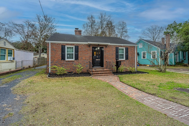 view of front of house featuring cooling unit and a front lawn