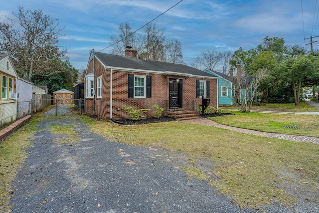 view of front facade with cooling unit and a front yard