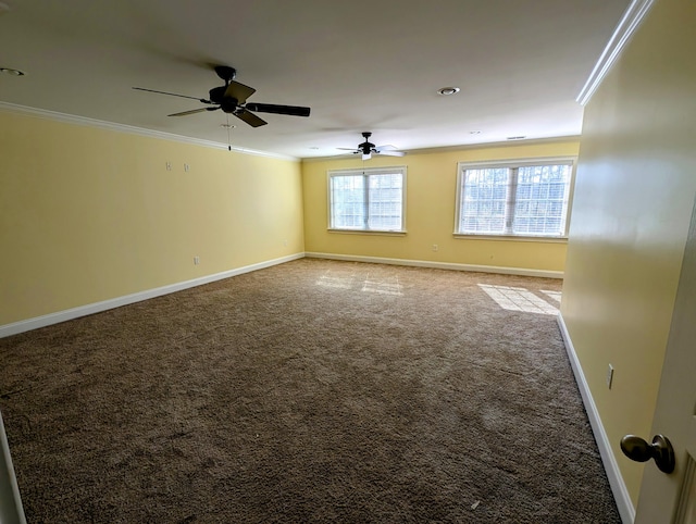 spare room with baseboards, a ceiling fan, carpet, and ornamental molding