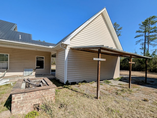 rear view of property featuring metal roof