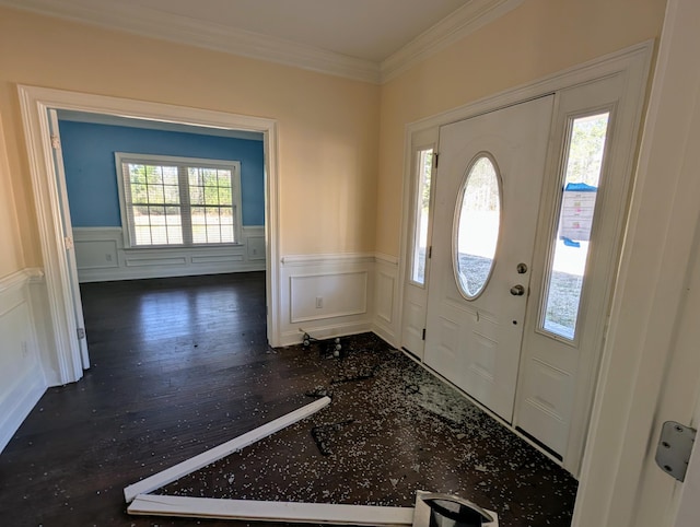 foyer entrance featuring crown molding, wood finished floors, and wainscoting
