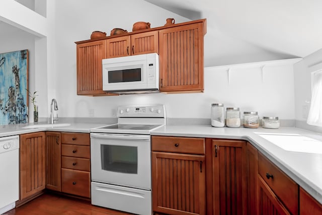 kitchen with sink, hardwood / wood-style flooring, and white appliances