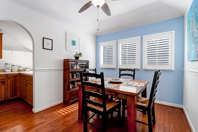 dining space with ceiling fan and hardwood / wood-style flooring