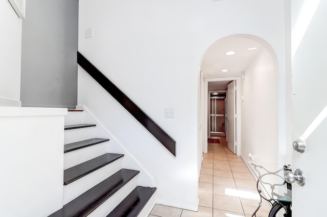 staircase with light tile floors