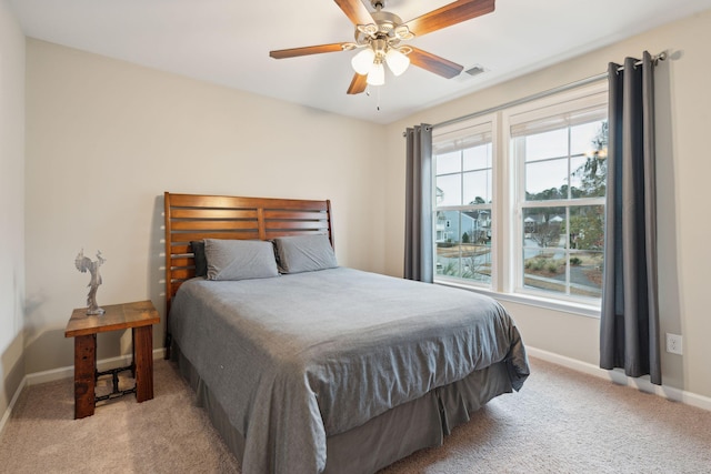 bedroom featuring ceiling fan and light carpet