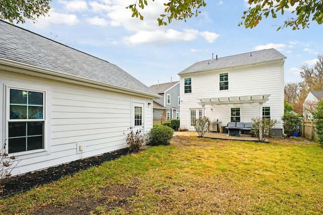 back of property with an outdoor living space, a yard, central air condition unit, and a pergola