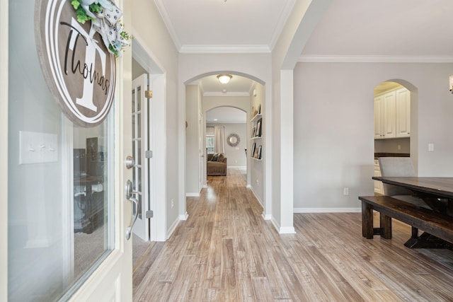 corridor with crown molding and light hardwood / wood-style floors