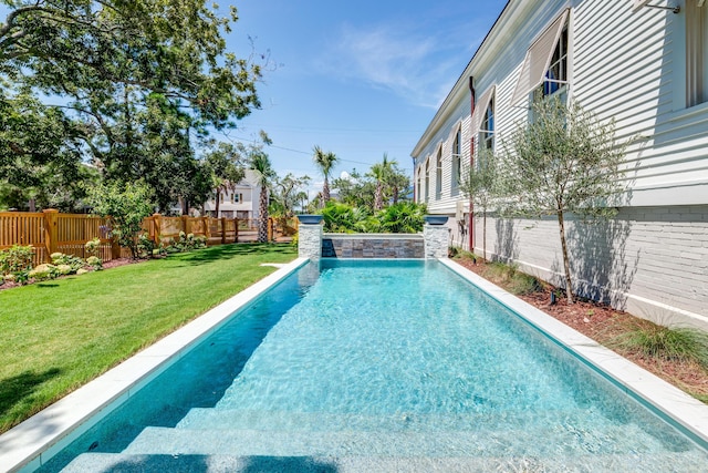 view of pool featuring a lawn, a fenced in pool, and a fenced backyard