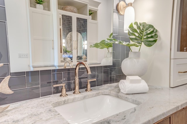 bathroom with vanity and backsplash