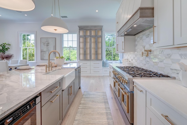 kitchen with double oven range, backsplash, crown molding, dishwashing machine, and custom exhaust hood