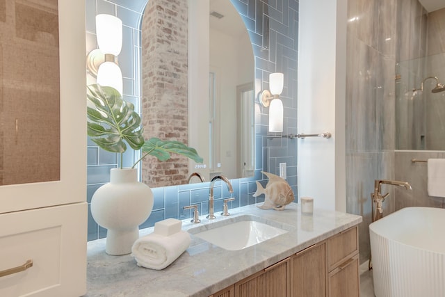 bathroom featuring a freestanding tub, visible vents, and vanity