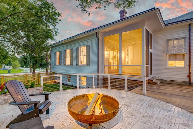 view of patio featuring a fire pit and fence