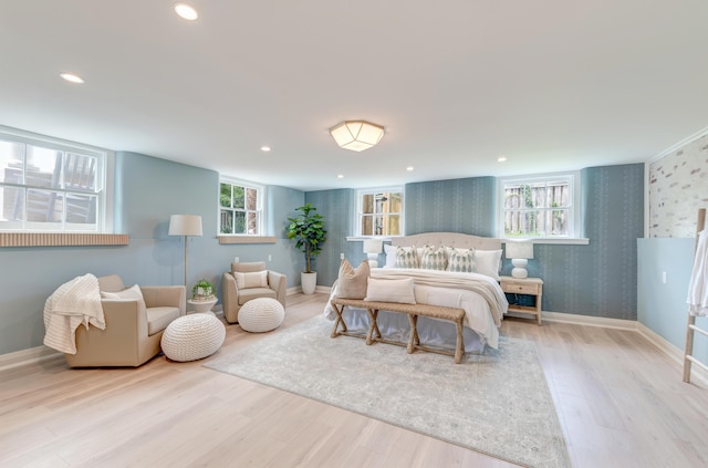 bedroom featuring wood finished floors, recessed lighting, wallpapered walls, baseboards, and an accent wall