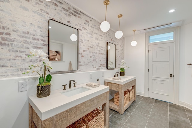 bathroom featuring a sink, two vanities, and tile patterned flooring