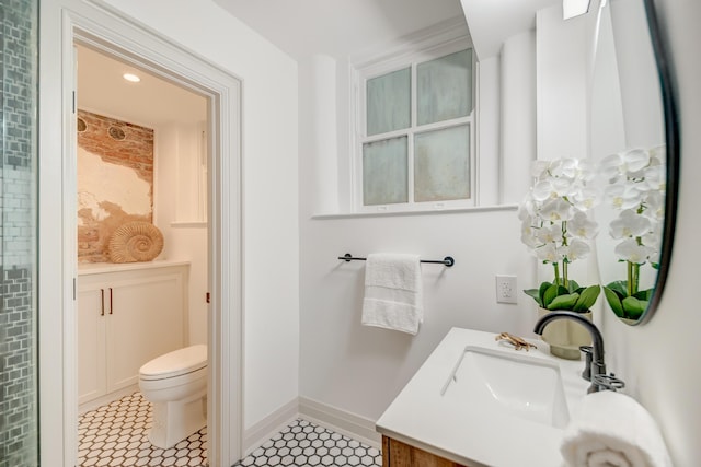 bathroom featuring tile patterned floors, toilet, vanity, and baseboards