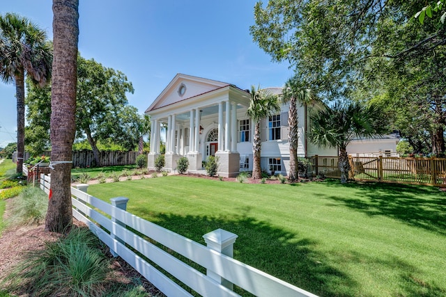 greek revival house featuring a front lawn, a porch, and fence private yard