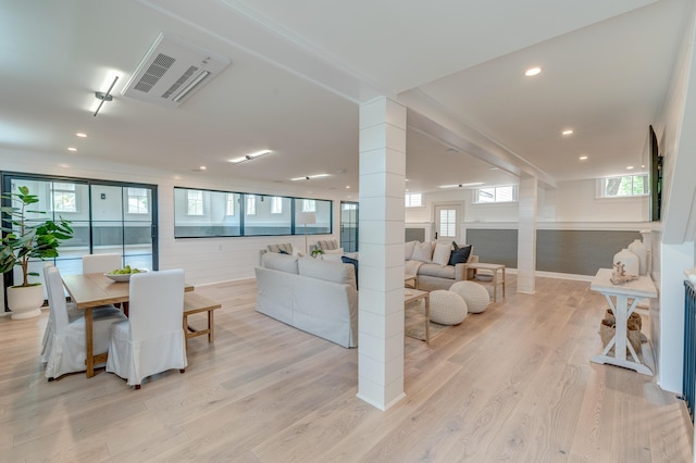 living room with recessed lighting, decorative columns, light wood-style floors, and visible vents