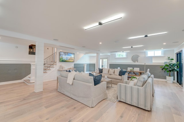 living room with stairway and light wood-style floors