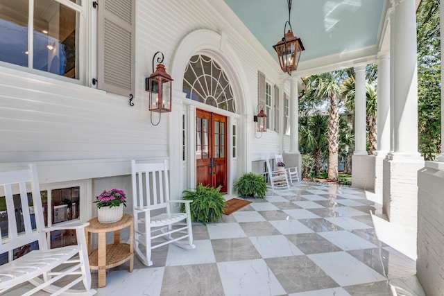 property entrance featuring french doors and covered porch