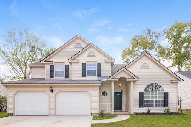 view of front of property with a garage and a front lawn