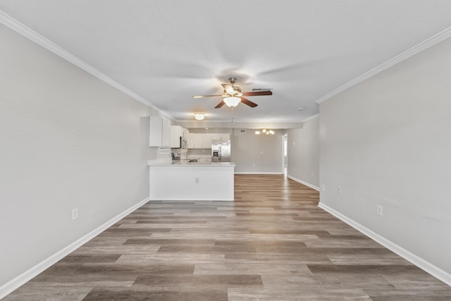 unfurnished living room with light wood-type flooring, ceiling fan, and crown molding