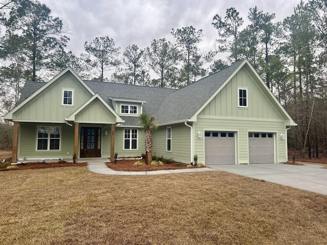 craftsman-style house featuring a garage and a front yard