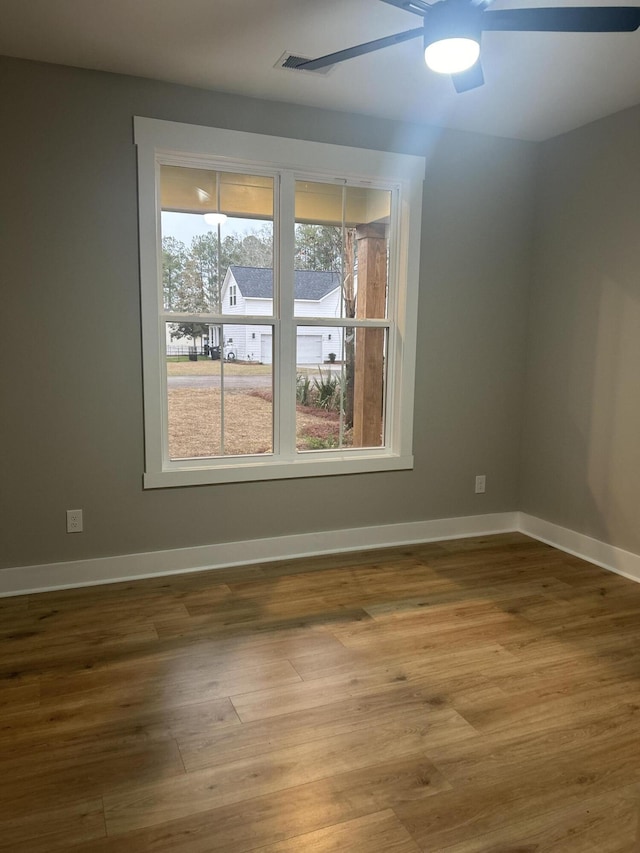 spare room featuring hardwood / wood-style floors and ceiling fan