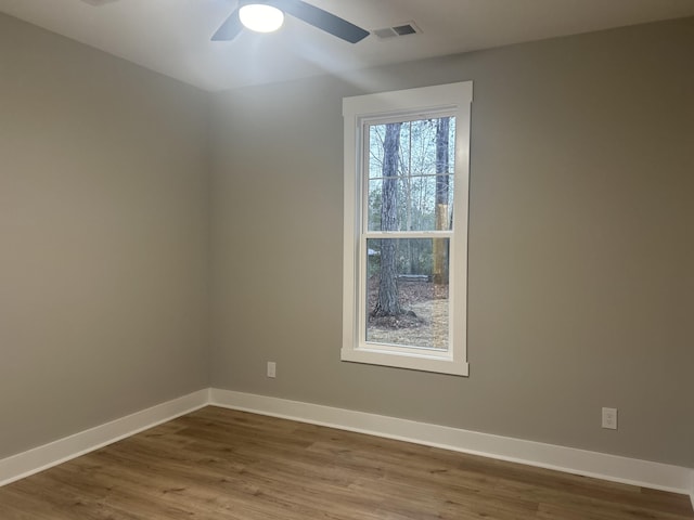 spare room with wood-type flooring and ceiling fan