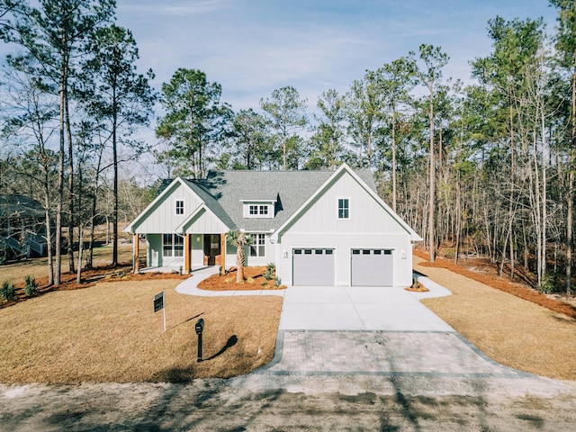 modern inspired farmhouse featuring board and batten siding, concrete driveway, a shingled roof, and an attached garage