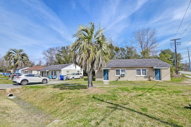 view of front of home featuring concrete block siding and a front lawn