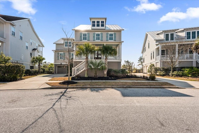 1962 Bellona St, Charleston, SC 29492 - view of front of house with concrete driveway, an attached garage, a standing seam roof, metal roof, and stairs