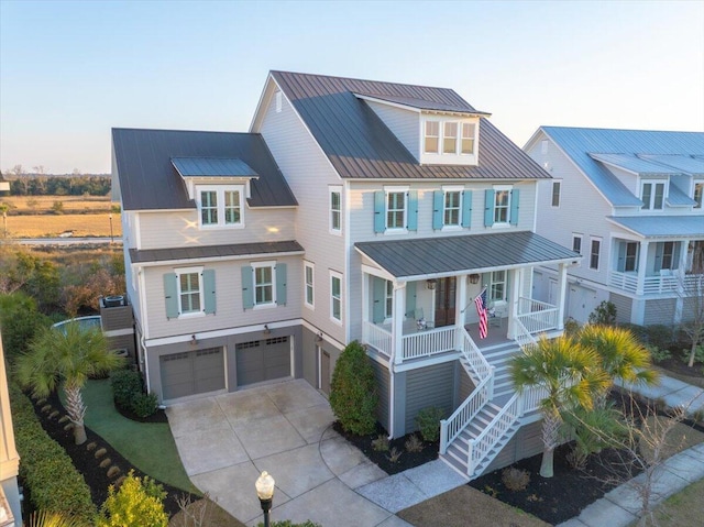 1962 Bellona St, Charleston, SC 29492 - beach home featuring metal roof, an attached garage, covered porch, stairway, and a standing seam roof