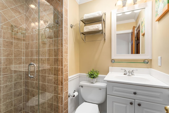 bathroom with walk in shower, toilet, vanity, and ornamental molding