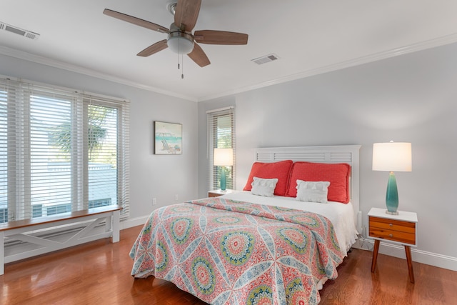 bedroom with ceiling fan, wood-type flooring, and crown molding