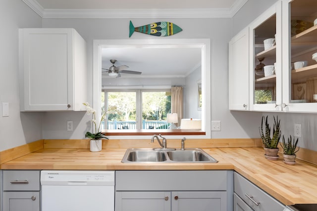 kitchen featuring wooden counters, ornamental molding, white dishwasher, ceiling fan, and sink