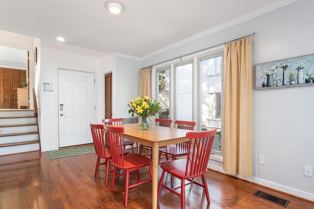 dining area with dark hardwood / wood-style flooring and ornamental molding