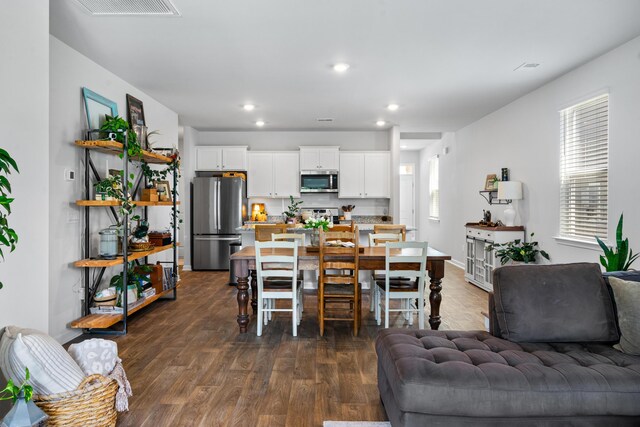 dining room featuring a wealth of natural light and dark hardwood / wood-style flooring